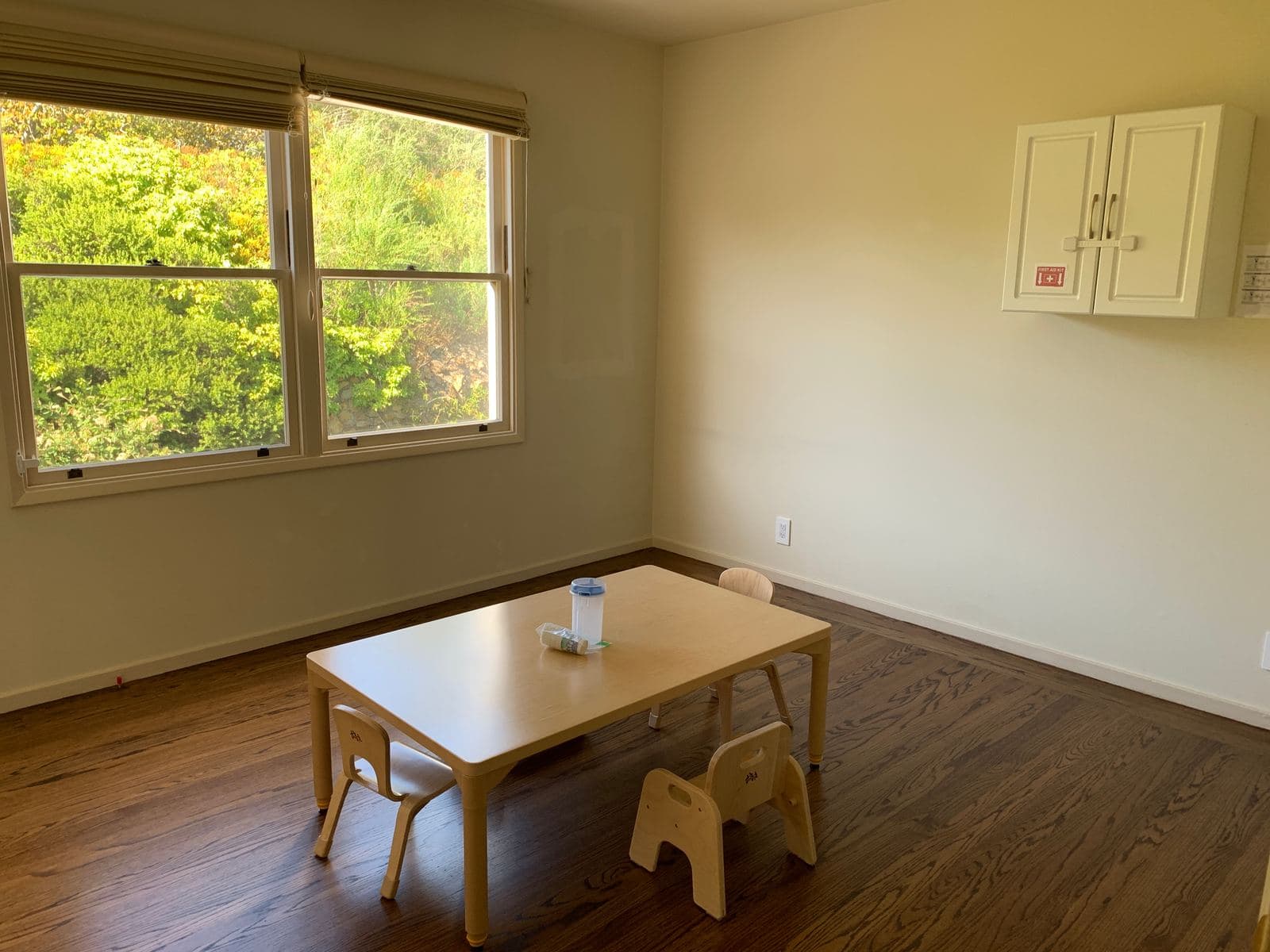 Indoor classroom with a child-sized table and chairs beside a sunny window at Wisely SF